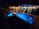 Inviting pool with spa at night, surrounded by patio furniture at 747 Brightwaters Ne Blvd, St Petersburg, FL 33704