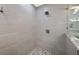 Modern shower with pebble floor and frameless glass enclosure at 747 Brightwaters Ne Blvd, St Petersburg, FL 33704