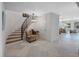Grand curved staircase with wrought iron railing and marble flooring at 747 Brightwaters Ne Blvd, St Petersburg, FL 33704