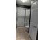 Bathroom with shower and toilet, dark walls, and tiled floor at 8003 Bally Money Rd, Tampa, FL 33610