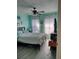 Bedroom with light teal walls and ceiling fan at 8003 Bally Money Rd, Tampa, FL 33610
