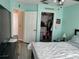 Bedroom with teal walls, ceiling fan, and walk-in closet at 8003 Bally Money Rd, Tampa, FL 33610