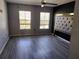Primary bedroom with gray vinyl plank flooring and large headboard at 8003 Bally Money Rd, Tampa, FL 33610