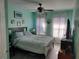 Bedroom with light teal walls and ceiling fan at 8003 Bally Money Rd, Tampa, FL 33610