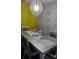 Elegant dining room featuring a silver table, decorative accents, and chandelier at 8003 Bally Money Rd, Tampa, FL 33610