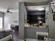 View of kitchen from dining area with pass-through and dark cabinets at 8003 Bally Money Rd, Tampa, FL 33610