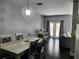 Bright dining room with a large table, chandelier, and hardwood floors at 8003 Bally Money Rd, Tampa, FL 33610