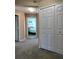 Hallway with carpet flooring, leading to bedroom and closet at 8003 Bally Money Rd, Tampa, FL 33610
