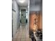 Clean hallway with light gray walls, tile flooring, and holiday decor at 8003 Bally Money Rd, Tampa, FL 33610
