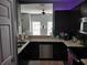 Modern kitchen with dark cabinetry, stainless steel appliances, and a breakfast bar at 8003 Bally Money Rd, Tampa, FL 33610