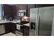 Modern kitchen with stainless steel appliances and dark brown cabinets at 8003 Bally Money Rd, Tampa, FL 33610