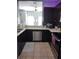 Modern kitchen with stainless steel appliances and dark brown cabinets at 8003 Bally Money Rd, Tampa, FL 33610