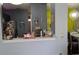 View of kitchen from dining area with dark cabinets and a pass-through at 8003 Bally Money Rd, Tampa, FL 33610