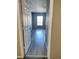 Bright living room with gray vinyl plank flooring and large window at 8003 Bally Money Rd, Tampa, FL 33610