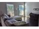 Comfortable living room with sectional sofa, hardwood floors, and plenty of natural light at 8003 Bally Money Rd, Tampa, FL 33610