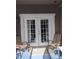 Relaxing patio with white French doors and comfortable seating at 8003 Bally Money Rd, Tampa, FL 33610