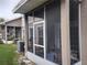 Spacious screened porch with seating and AC unit at 8003 Bally Money Rd, Tampa, FL 33610