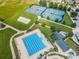 Aerial view of the community recreational facilities, including a volleyball court, tennis courts, and swimming pool at 8319 Swiss Chard Cir, Land O Lakes, FL 34637