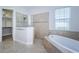 Bathroom featuring a soaking tub, separate shower, and stylish tile work at 8319 Swiss Chard Cir, Land O Lakes, FL 34637