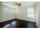Bright bedroom featuring hardwood floors, neutral walls, and natural light at 8319 Swiss Chard Cir, Land O Lakes, FL 34637
