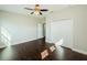 Spacious bedroom features hardwood floors, ceiling fan, and closet at 8319 Swiss Chard Cir, Land O Lakes, FL 34637