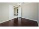 Bonus room with gleaming hardwood floors and an open doorway at 8319 Swiss Chard Cir, Land O Lakes, FL 34637