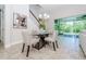 Bright dining area features a modern glass table set, staircase views and outdoor views through sliding glass door at 8319 Swiss Chard Cir, Land O Lakes, FL 34637