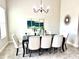 Elegant dining room features a chandelier, stylish decor, and a table with seating for eight at 8319 Swiss Chard Cir, Land O Lakes, FL 34637