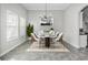 Bright dining room featuring a modern chandelier and seating for four at 8319 Swiss Chard Cir, Land O Lakes, FL 34637