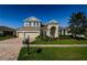 Two-story house with a three-car garage and manicured lawn at 8319 Swiss Chard Cir, Land O Lakes, FL 34637