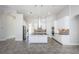 Modern kitchen with white cabinets, granite counters and island at 8319 Swiss Chard Cir, Land O Lakes, FL 34637