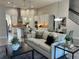 Stylish living space blending modern decor with an open concept, featuring a staircase and an adjacent kitchen at 8319 Swiss Chard Cir, Land O Lakes, FL 34637
