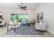Sun-filled living room with tile flooring, area rug and sliding doors for great indoor/outdoor living at 8319 Swiss Chard Cir, Land O Lakes, FL 34637