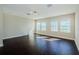 Bright living room features hardwood floors, neutral walls, and sun-filled windows at 8319 Swiss Chard Cir, Land O Lakes, FL 34637