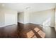 Open living room with hardwood flooring, large closet, and natural light at 8319 Swiss Chard Cir, Land O Lakes, FL 34637