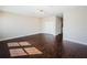 Spacious living room with dark hardwood floors, closet, and natural lighting at 8319 Swiss Chard Cir, Land O Lakes, FL 34637