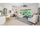 Comfortable living area with tile floors, an area rug and seamless indoor/outdoor living with a sliding glass door at 8319 Swiss Chard Cir, Land O Lakes, FL 34637