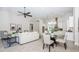 Open-concept living room boasts neutral tones, modern furnishings, and seamless flow to the dining area at 8319 Swiss Chard Cir, Land O Lakes, FL 34637