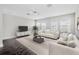 Bright living room with multiple windows and comfortable seating, perfect for entertaining guests at 8319 Swiss Chard Cir, Land O Lakes, FL 34637
