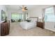 Serene primary bedroom features neutral tones, an attached sitting area, and abundant natural light for a peaceful retreat at 8319 Swiss Chard Cir, Land O Lakes, FL 34637