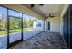 Screened patio with brick pavers, ceiling fan, and view of the landscaped backyard at 8319 Swiss Chard Cir, Land O Lakes, FL 34637