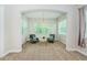 Bright sitting room with comfortable gray chairs, modern lighting, and a neutral color palette at 8319 Swiss Chard Cir, Land O Lakes, FL 34637