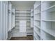 Spacious walk-in closet features custom shelving, drawers, and hanging rods for optimal organization at 8319 Swiss Chard Cir, Land O Lakes, FL 34637
