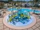 Aerial view of a vibrant community water park with slides, pools, and shaded seating areas at 8319 Swiss Chard Cir, Land O Lakes, FL 34637