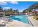 Community pool with lounge chairs and lush landscaping at 9481 Highland Oak Dr # 703, Tampa, FL 33647