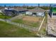 Backyard with a fenced-in lawn and partially built home at 1074 Signet Dr, Apollo Beach, FL 33572