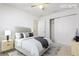 Bedroom with neutral walls, a ceiling fan, and closet and bathroom entrances at 10817 Great Carlisle Ct, Riverview, FL 33578