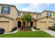 Front view of two-story townhouses with attached garages and landscaping at 10817 Great Carlisle Ct, Riverview, FL 33578