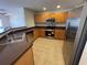 Well-lit kitchen with stainless steel appliances and light wood cabinets at 10817 Great Carlisle Ct, Riverview, FL 33578