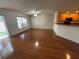 Bright living room with hardwood floors and access to kitchen at 10817 Great Carlisle Ct, Riverview, FL 33578